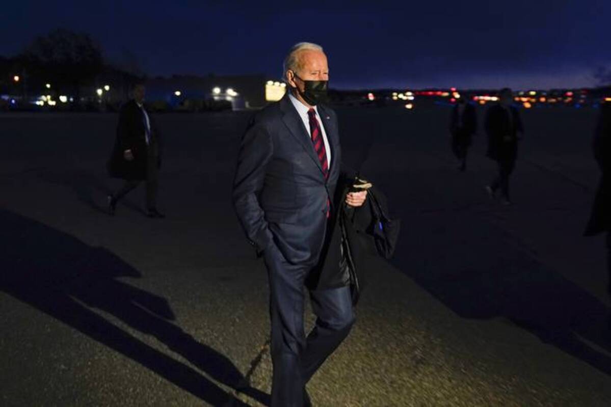President Biden walks over to speak to reporters as he prepares to depart Manchester-Boston Regional Airport on Tuesday in Manchester, N.H. (Evan Vucci/AP)