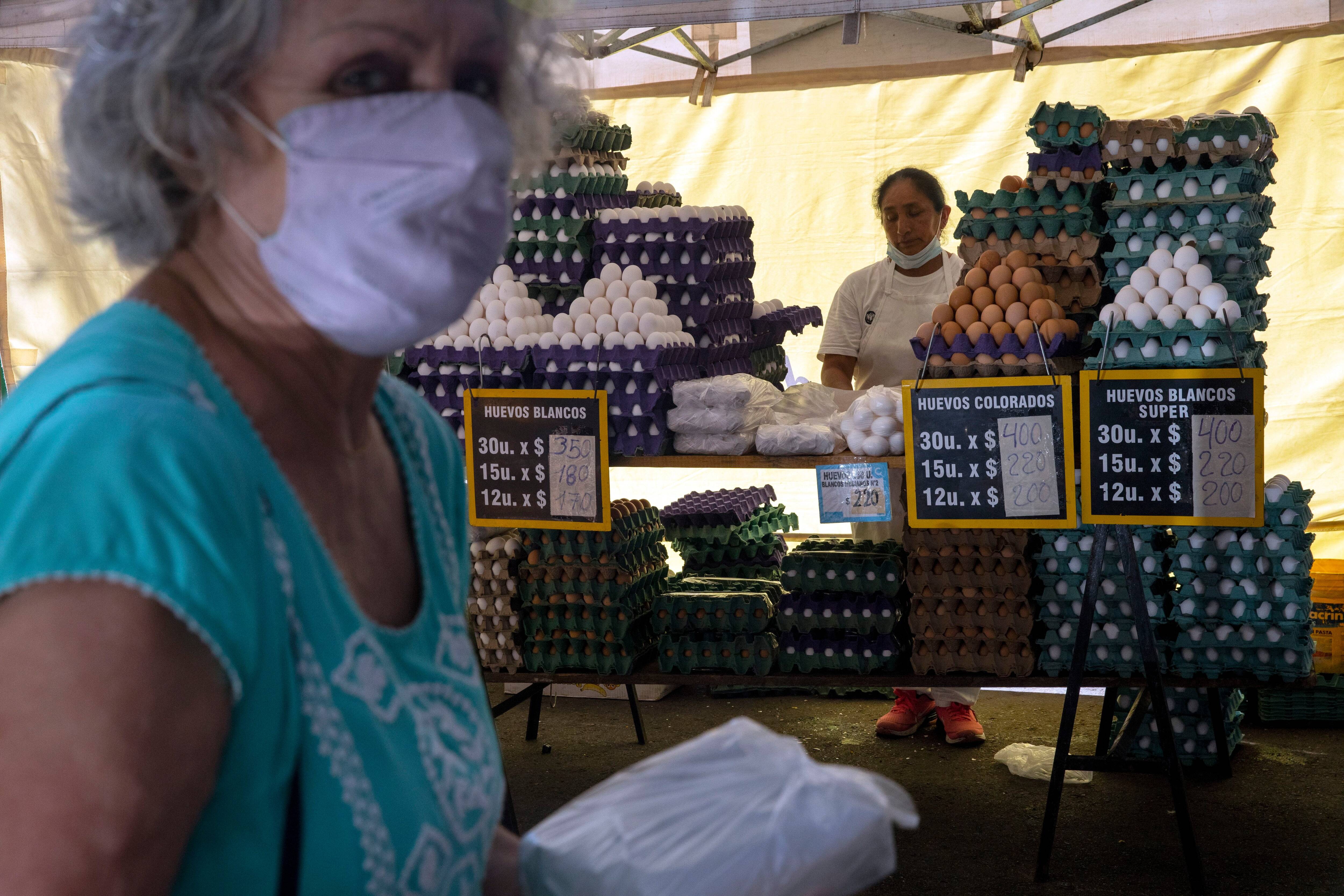 A woman walks away after purchasing eggs at a food fair in Buenos Aires on Jan. 13, 2022. (Rodrigo Abd/AP)