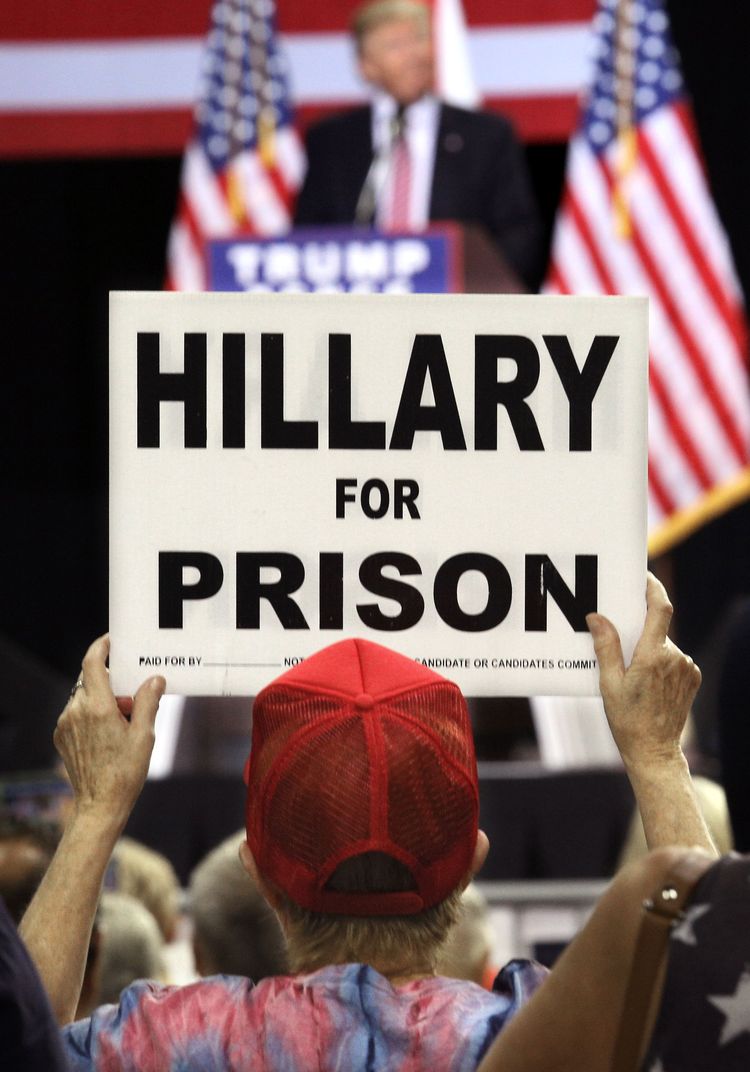 A Trump supporter holds up up a placard at a rally in&nbsp;Kissimmee, Florida. (Gregg Newton/AFP/Getty)</p>  