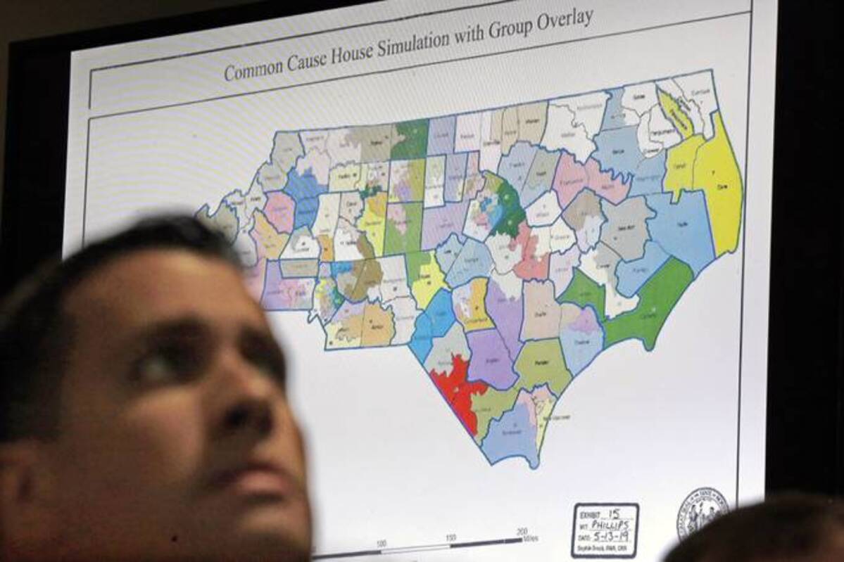 A state district map is shown as a three-judge panel of the Wake County Superior Court presides over the trial of Common Cause, et al. v. Lewis, et al, in Raleigh, N.C. (Gerry Broome/AP)