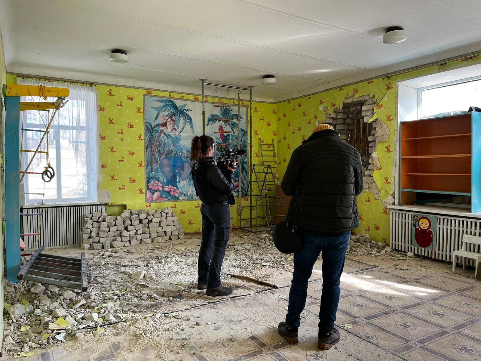 Whitney Leaming and Salwan Georges reporting in a kindergarten hit by artillery in Stanytsia Luhanska, eastern Ukraine, in February.