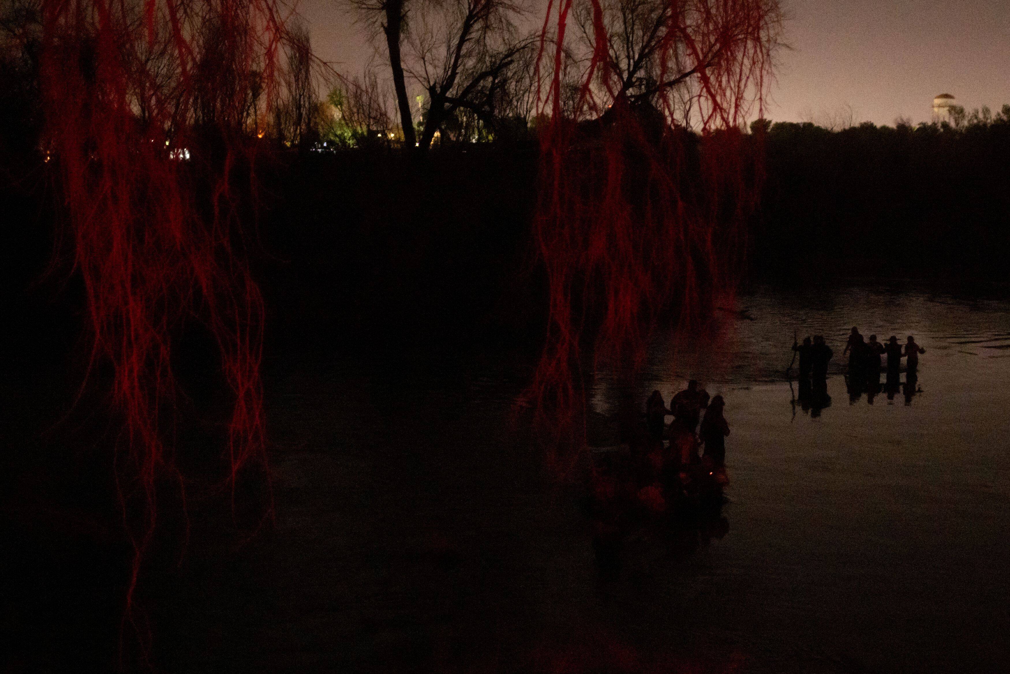 Migrants cross the Rio Grande into Roma, Tex., from Mexico last month. (Adrees Latif/Reuters)