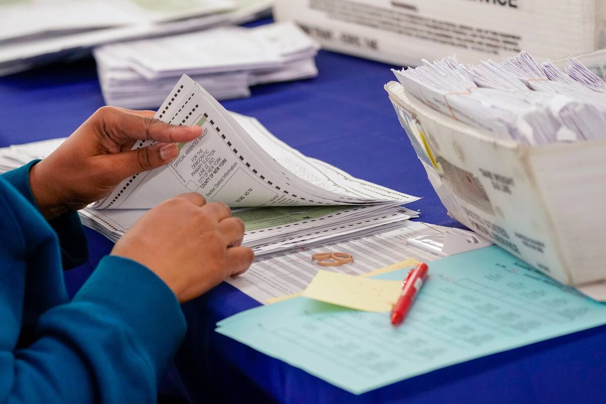 New York City Board of Election staff member counts absentee ballots in the primary election on July 2, 2021. (Mary Altaffer/AP Photo)