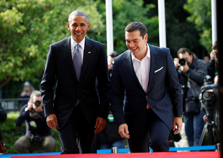 Obama walks with Greek Prime Minister Alexis Tsipras upon his arrival in Athens. (Reuters/Kevin Lamarque)</p>  