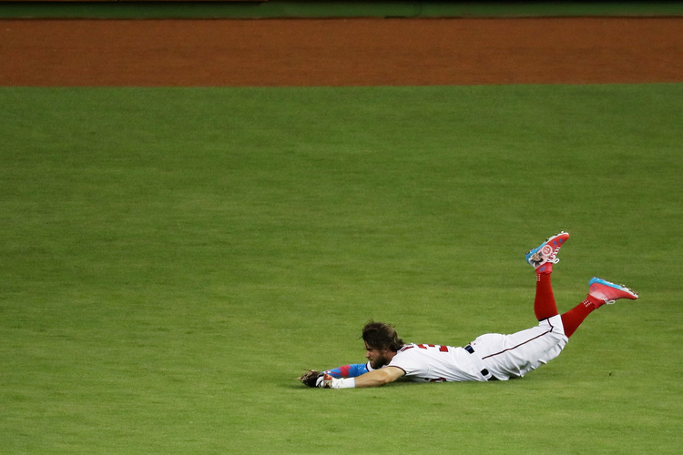 Bryce Harper of the Nationals catches a ball hit by Kansas City Royals' Salvador Perez during the MLB All-Star Game in Miami. (Rob Carr/Getty Images)  