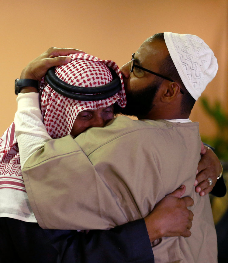 A Yemeni detainee (R) freed from Gitmo is hugged after his arrival at King Khalid International Airport in Riyadh, Saudi Arabia, a few hours ago. (Faisal Al Nasser/Reuters)</p>