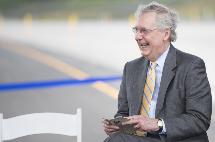 Senate Majority Leader Mitch McConnell laughs during a ribbon-cutting ceremony yesterday for Exit 30 on Interstate 65 in Bowling Green, Ky. (Austin Anthony/Daily News via AP)</p>  