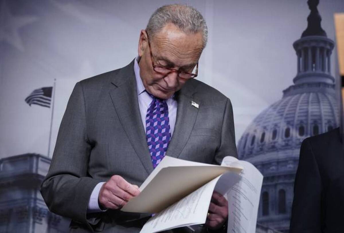 Senate Majority Leader Chuck Schumer (D-N.Y.) reads over notes during a news conference following a closed-door caucus lunch yesterday. (J. Scott Applewhite/AP)