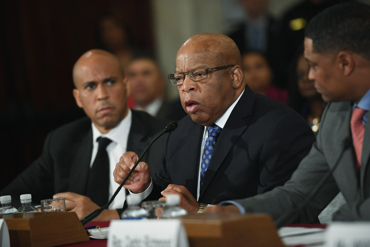 John Lewis speaks as Cory Booker and Cedric Richmond look on during the confirmation hearing for Jeff Sessions. (Matt McClain/The Washington Post)</p>  