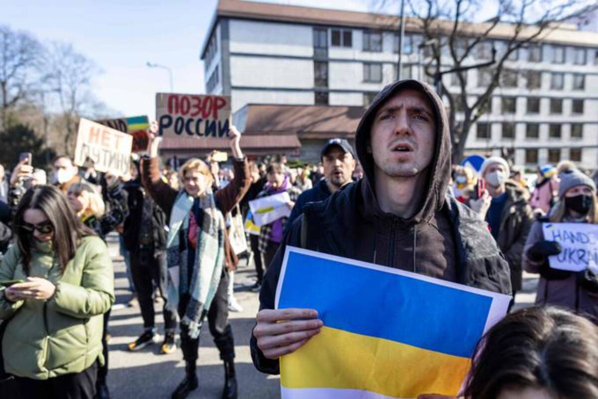 Ukrainian and Polish demonstrators protest against Russia's invasion of Ukraine, in front of Russian embassy in Warsaw, Poland, on February 24, 2022. (Photo by WOJTEK RADWANSKI/AFP via Getty Images)