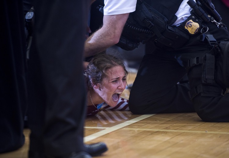 Police cuff a protester who&nbsp;jumped into the buffer area during a Clinton rally in&nbsp;Des Moines.&nbsp;(Melina Mara/The Washington Post)</p>  