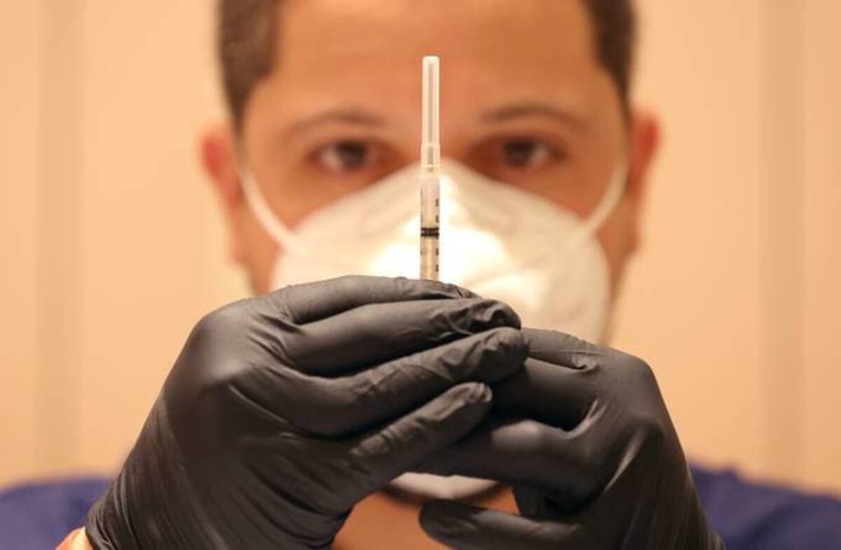 A syringe is filled with a coronavirus vaccine booster shot in California. (Justin Sullivan/Getty Images)
