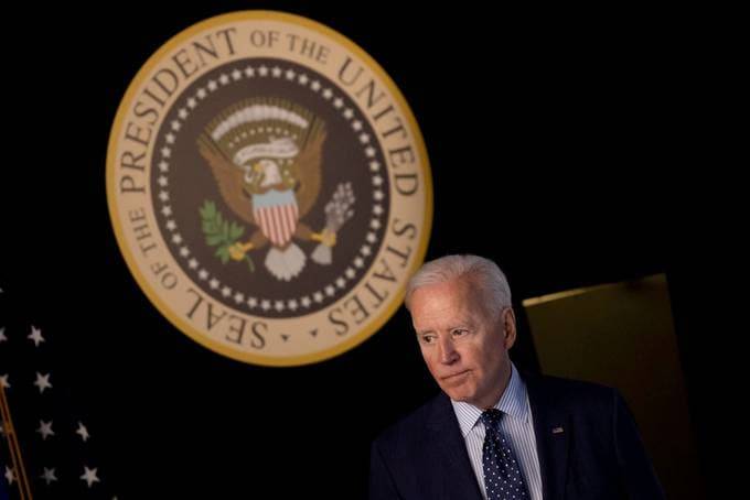 President Biden departs the Eisenhower Executive Office Building's South Court Auditorium last month after giving an update on his administration's coronavirus response. (Carlos Barria/Reuters)