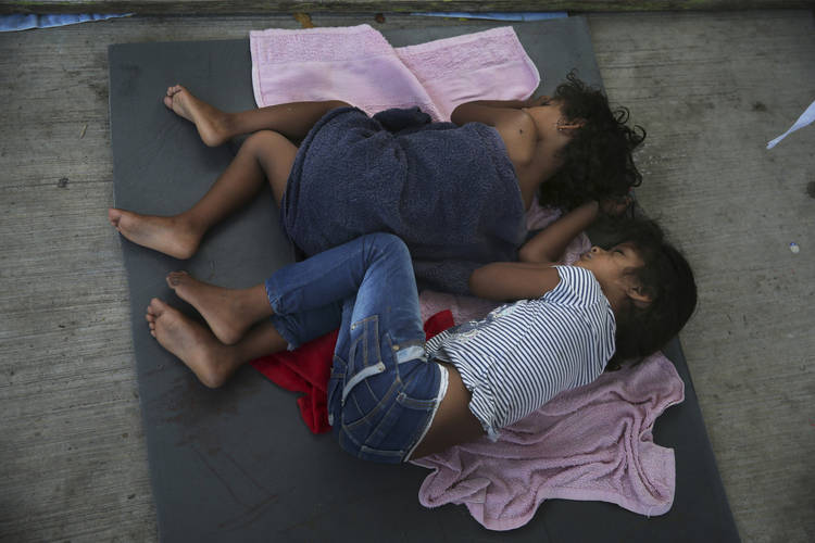 Children sleep on a mattress on the floor of a migrant shelter in Nuevo Laredo, Mexico. (Marco Ugarte/AP)  