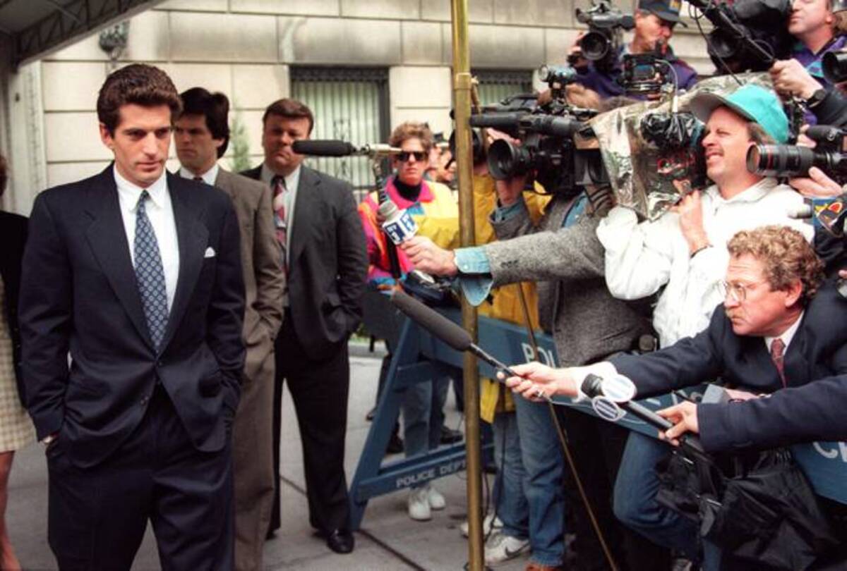 In this May 20, 1994 photo, John F. Kennedy Jr. answers journalists' questions soon after his mother Jackie Kennedy's death in New York. (Timothy A. Clary/AFP file)
