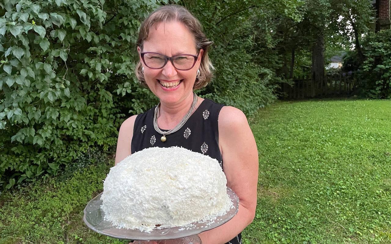 Dawn Charles takes her gâteau d'Hélène (coconut cake) to the neighborhood barbeque. It was a hit. (Ron Charles/The Washington Post)