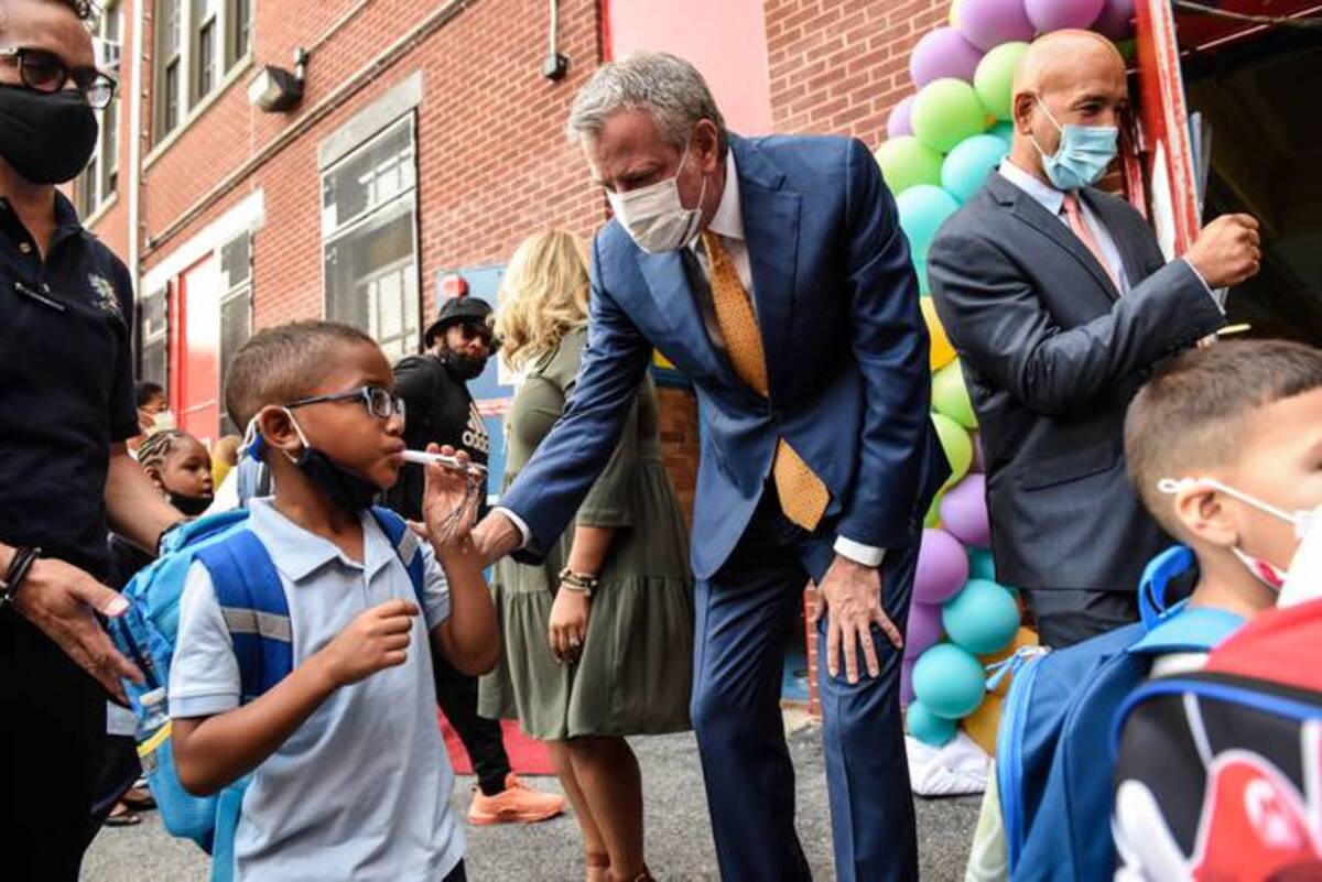 Bill de Blasio, mayor of New York, greets a student on the first day of classes at a public school in the Bronx. (Stephanie Keith/Bloomberg)