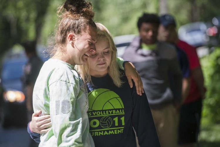 Clarksburg High School juniors Courtney Witmer, 16, left, and Baleigh Louro, 17, visit the crash site where three of their classmates died. (Amanda Voisard/For the Washington Post)</p>  